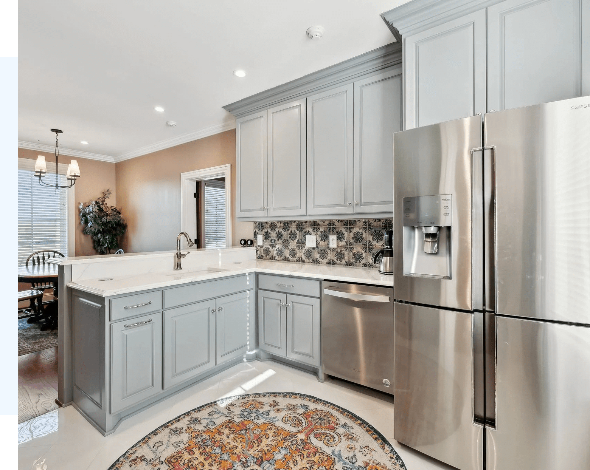 Modern kitchen with gray cabinets and appliances.