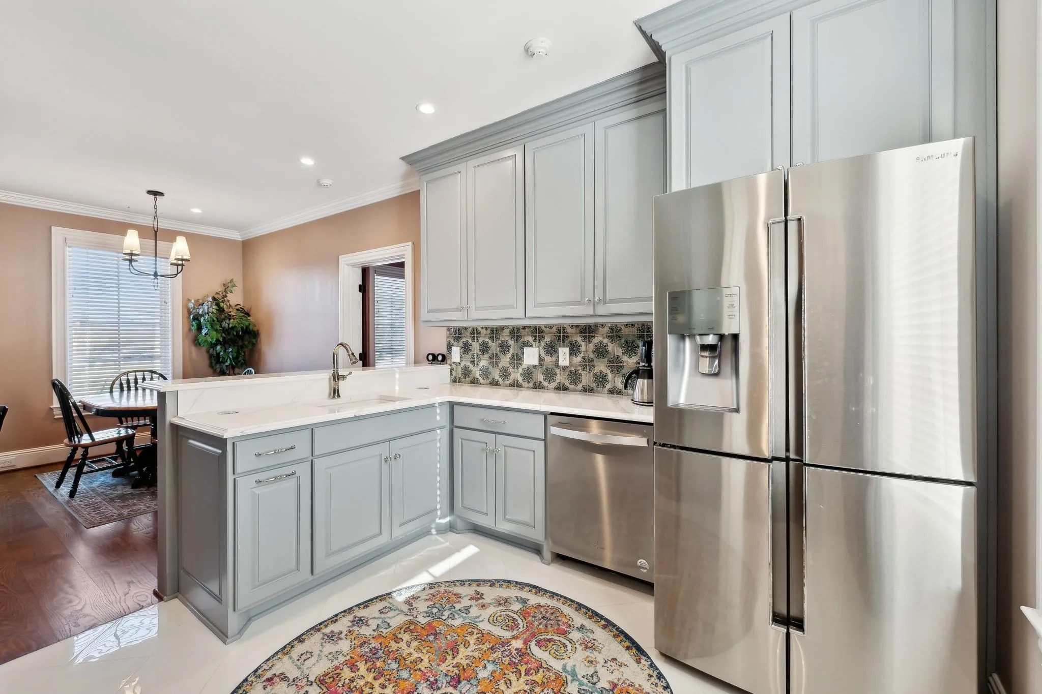 Modern kitchen with grey cabinets and stainless steel appliances.