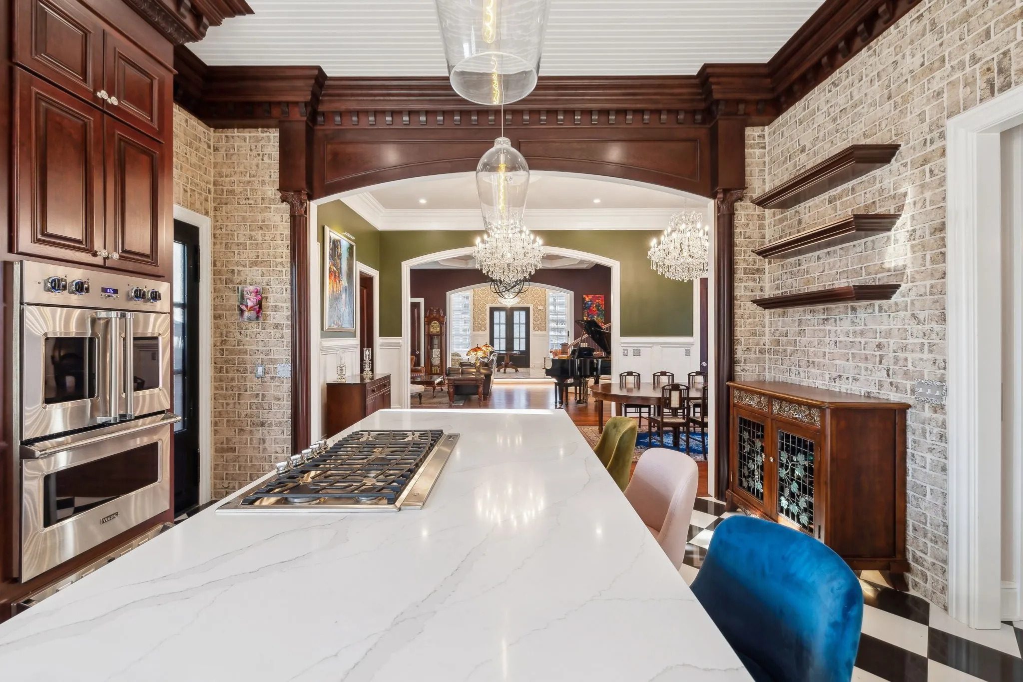 Elegant kitchen island with white countertop and stylish seating.