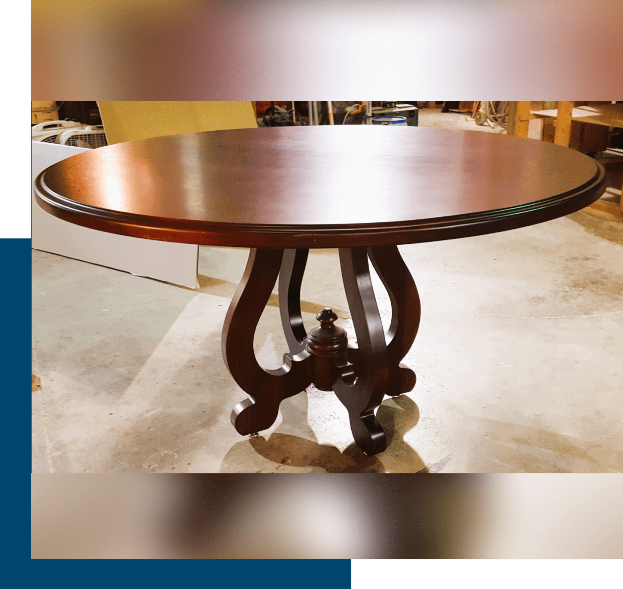 j1 Round wooden table with ornate pedestal base on casters.