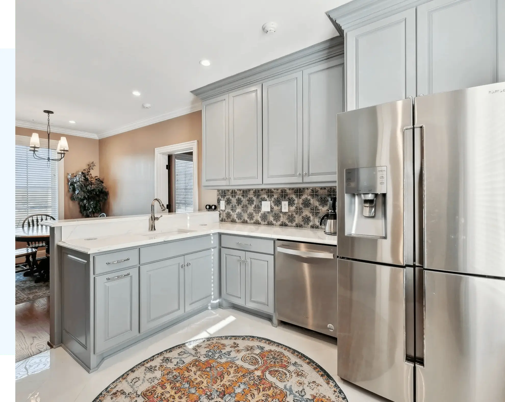 Modern kitchen with gray cabinets and appliances.